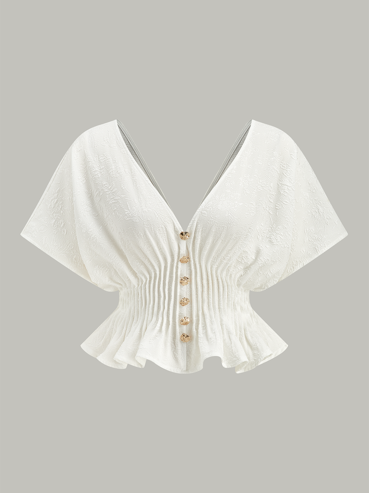 Haut péplum à boutons texturés