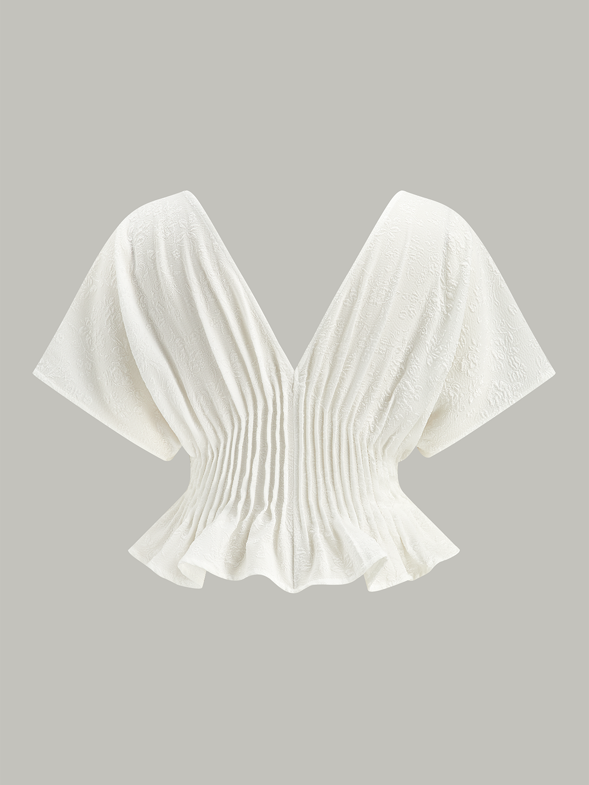 Haut péplum à boutons texturés